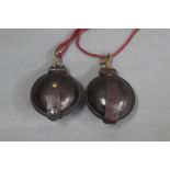 Two leather circular pouches, possibly for percussion caps.