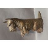 A cast iron fireside companion stand in the form of a begging Scottie dog with poker and brush