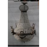 A Chandelier, mounted with four metal stags heads, overall length +/- 92 cm.