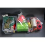 A plastic box and two bags containing McHardys of Carlisle fly tying materials,