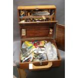 A travelling fly tying case filled with feathers, vice, scissors etc.