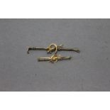A 9 ct gold stock pin in the form of a fox and horseshoe, weight 2 grams,