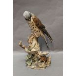 Border Fine Arts a kestrel with mouse figure, signed Hayton '77, height 24 cm.