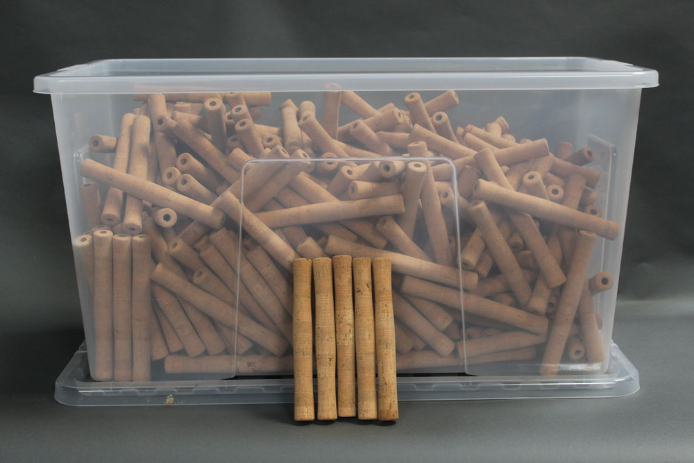 A large plastic box of cork fishing rod handles, internal diameter 10 mm, length 20.5 cm.