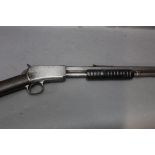 A Winchester cal 22 short pump action rifle, with a hexagonal barrel and open sights,