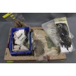 A box of fly tying materials, Metz saddle, various hooks, feathers etc.