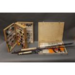 A wooden double sided fly box, containing +/- 360 trout flies,