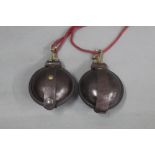 Two leather circular pouches, possibly for percussion caps.