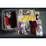 A plastic box containing various cock and hen capes for fly tying, to include Keough, Veniard,