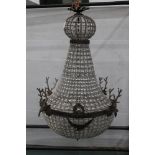 A Chandelier, mounted with four metal stags heads, overall length +/- 92 cm.
