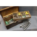 A homemade tackle box with lift out section, containing various sea fishing hooks,