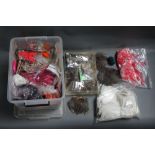 A plastic box filled with various cock capes for fly tying.