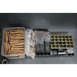 A plastic box filled with cork fly rod handles, together with four trays of rod eyes.