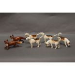 Five Beswick first version fox hounds, together with two foxes - one gloss one matt.