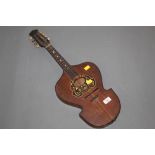 An old 8 string flat back mandolin with shaped body,