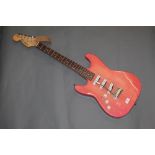 A Lindo left handed electric guitar with pale pink lacquered body, 99 cm long.