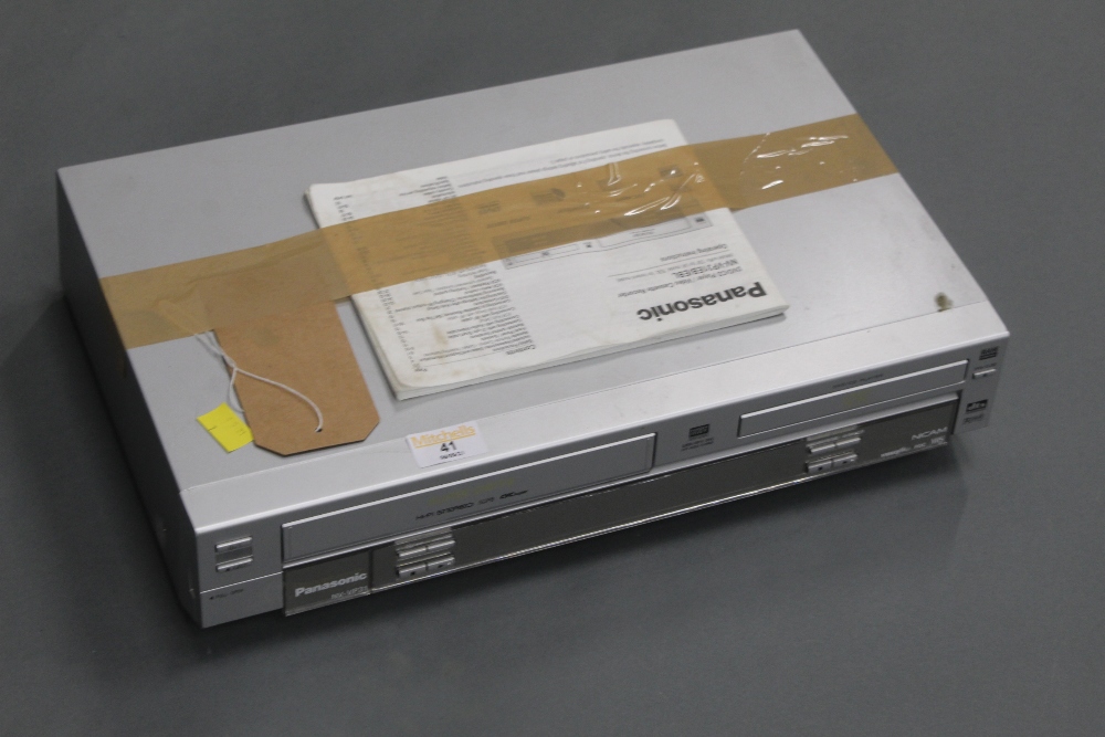 A Panasonic NV-VP31 Super Drive DVD / CD / Video cassette recorder, with instructions.