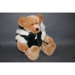 A Harrord's Christmas 2001 Teddy Bear, having a light brown plush covered body,