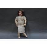 An Armand Marseille 390 bisque headed doll, with sleep eyes, open mouth with four teeth,