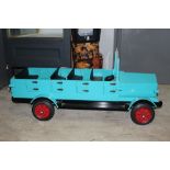 A scratch built wooden open top bus, having four rows of seating, four individual doors,