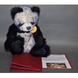 A soft plush "Tiffy" Charlie Bear, CB604686, having navy blue and white fur body,