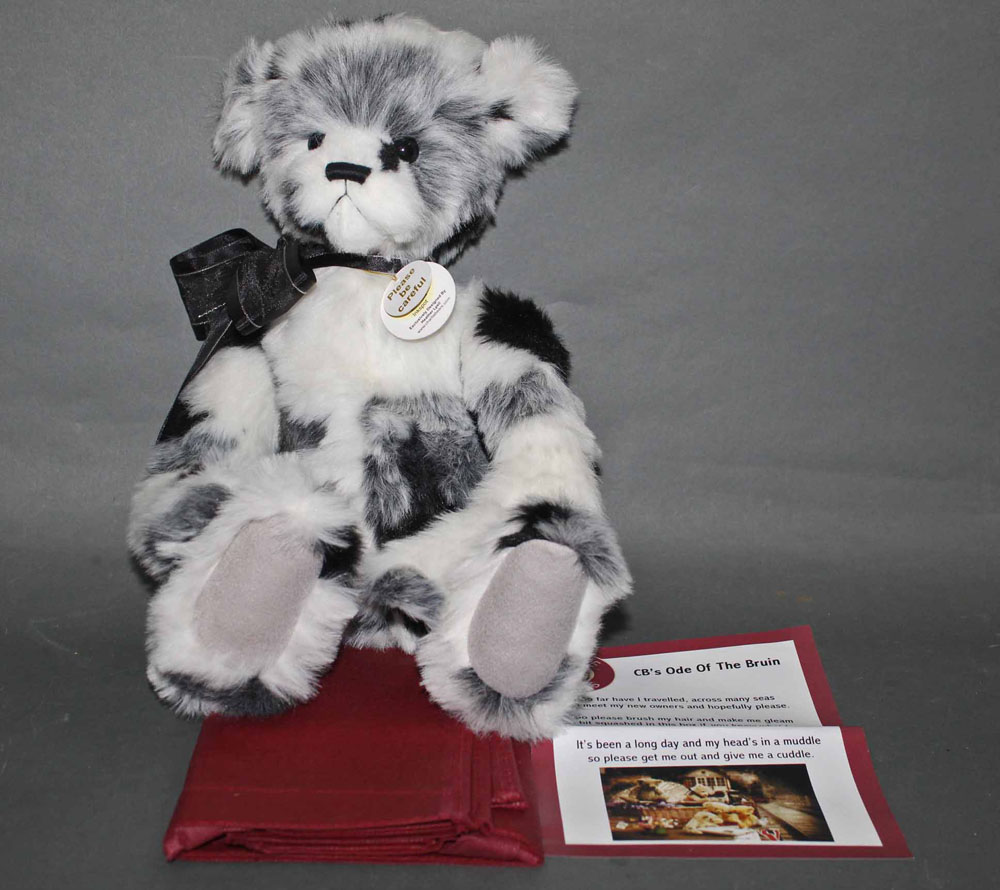 A soft plush "Inkspot" Charlie Bear, CB620009, having black, white, and grey fur covered body,