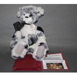 A soft plush "Inkspot" Charlie Bear, CB620009, having black, white, and grey fur covered body,
