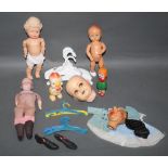 A shoe box containing miscellaneous doll items, to include a bisque head doll, Roddy dolls,