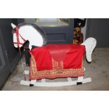 A painted wooden rocking horse, of traditional form, having painted features, fur mane,