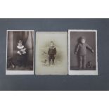 A group of three Victorian and other photographs of children with their dolls, teddy bears,