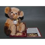 A soft plush "Phillip" Charlie Bear, CB114748B, having patterned brown fur body,
