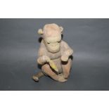 An Alpha Farnell style seated monkey, having partial mohair covered body,