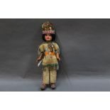 An Armand Marseille bisque headed Native American doll, having an open mouth with four teeth,