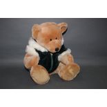 A Harrod's Teddy Bear, Christmas back pack, having a soft light brown plush covered body,