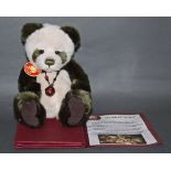 A soft plush "Mistletoe" Charlie Bear, CB614989, having green and white fur covered body,