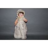 An Arman Marseille 985 bisque head doll, having sleep eyes, open mouth with two teeth,