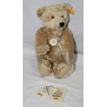 A Steiff Classic 1920 replica teddy bear, yellow label and button attached to its ear,