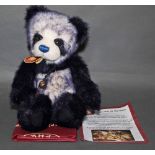 A soft plush "Tiffy" Charlie Bear, CB604686, having navy blue and white fur covered body,