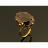 A 9 ct gold ladies dress ring with smoky stone, Size M.
