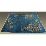 A large Chinese blue ground foliate patterned carpet with fringed ends.