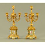 A pair of gilt painted metal and Sevres style porcelain panelled three branch candelabra.