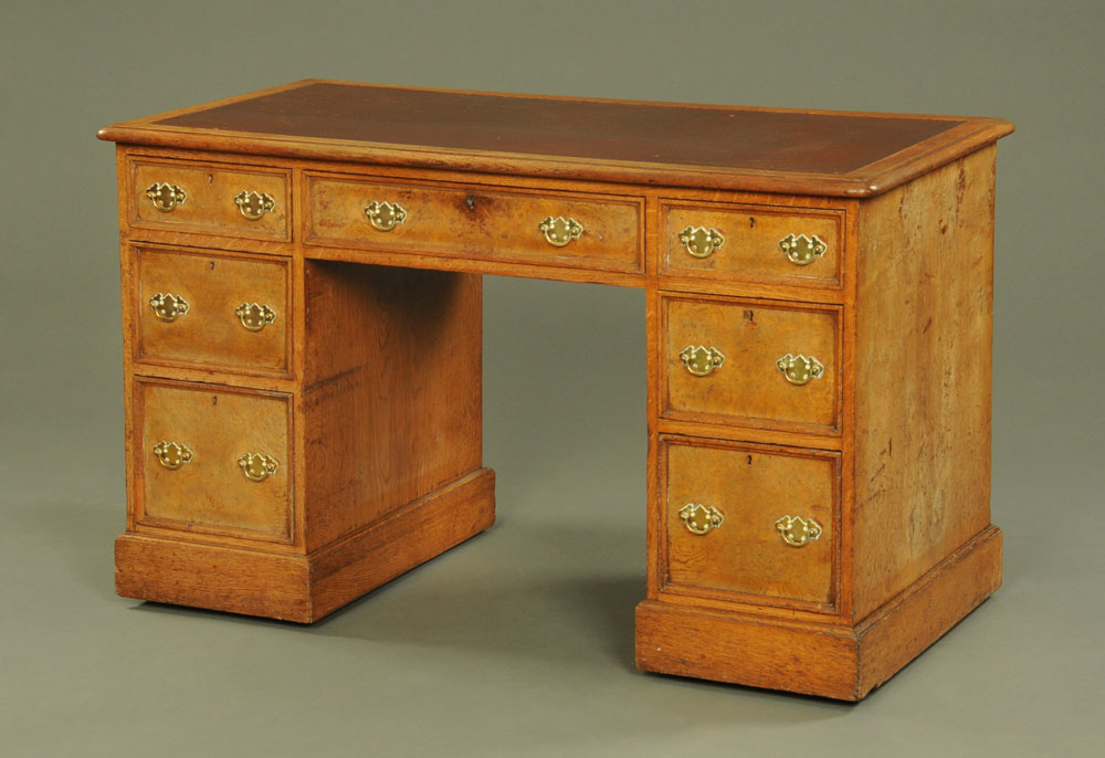 A late Victorian burr oak desk, with rounded corners,