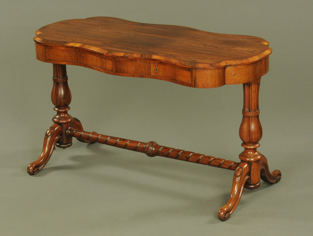 A Victorian rosewood stretcher table, of serpentine outline,