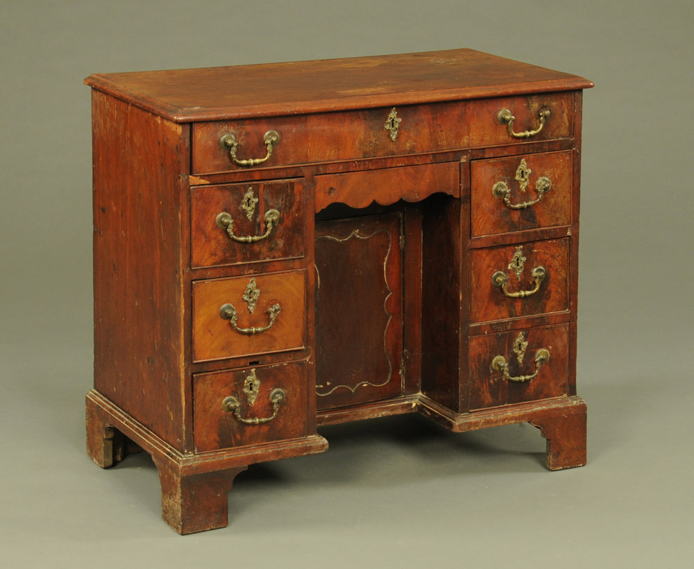 A Georgian mahogany kneehole desk, with long drawer kneehole cupboard,