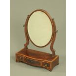 A 19th century mahogany dressing table mirror, oval with bevelled glass,