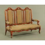 A Victorian mahogany framed settee, with three chair back, scroll arms,