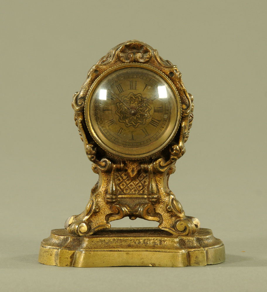 A miniature brass mantle clock, with pocket watch Verge movement by Thomas Hall Rumsey.