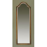 A walnut framed wall mounting dressing mirror, with bevelled glass. Height 143 cm, width 50 cm.