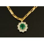 An 18 ct white gold emerald and diamond pendant, with 18 ct gold chain. Chain length 56 cm.