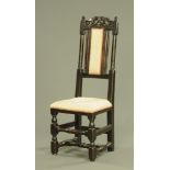 An antique oak hall chair, with upholstered back pad and seat and raised on turned front legs.